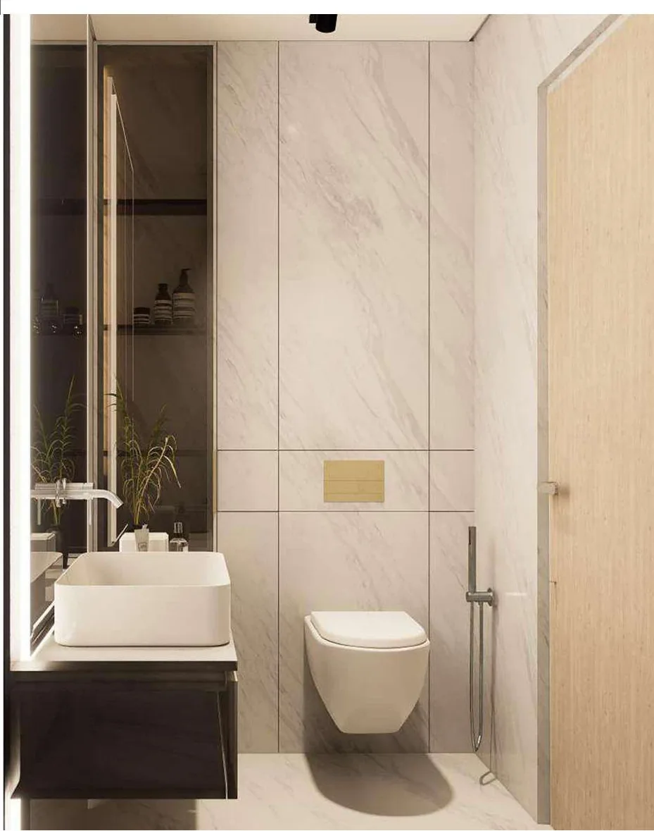 Guest bathroom with a vessel basin on a dark timber vanity, brass flush plate and full-height marble-effect tiling.