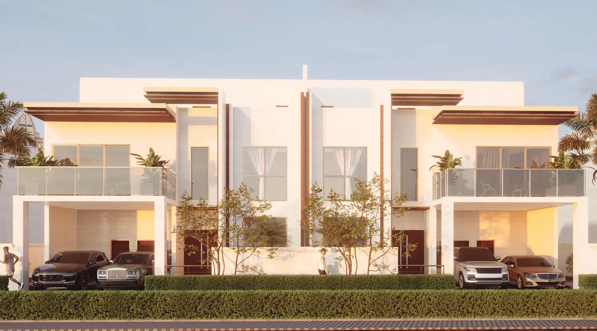 The Dubai twin villa at dusk, both mirrored units lit from within behind a clipped hedge and timber-lined carport canopies.